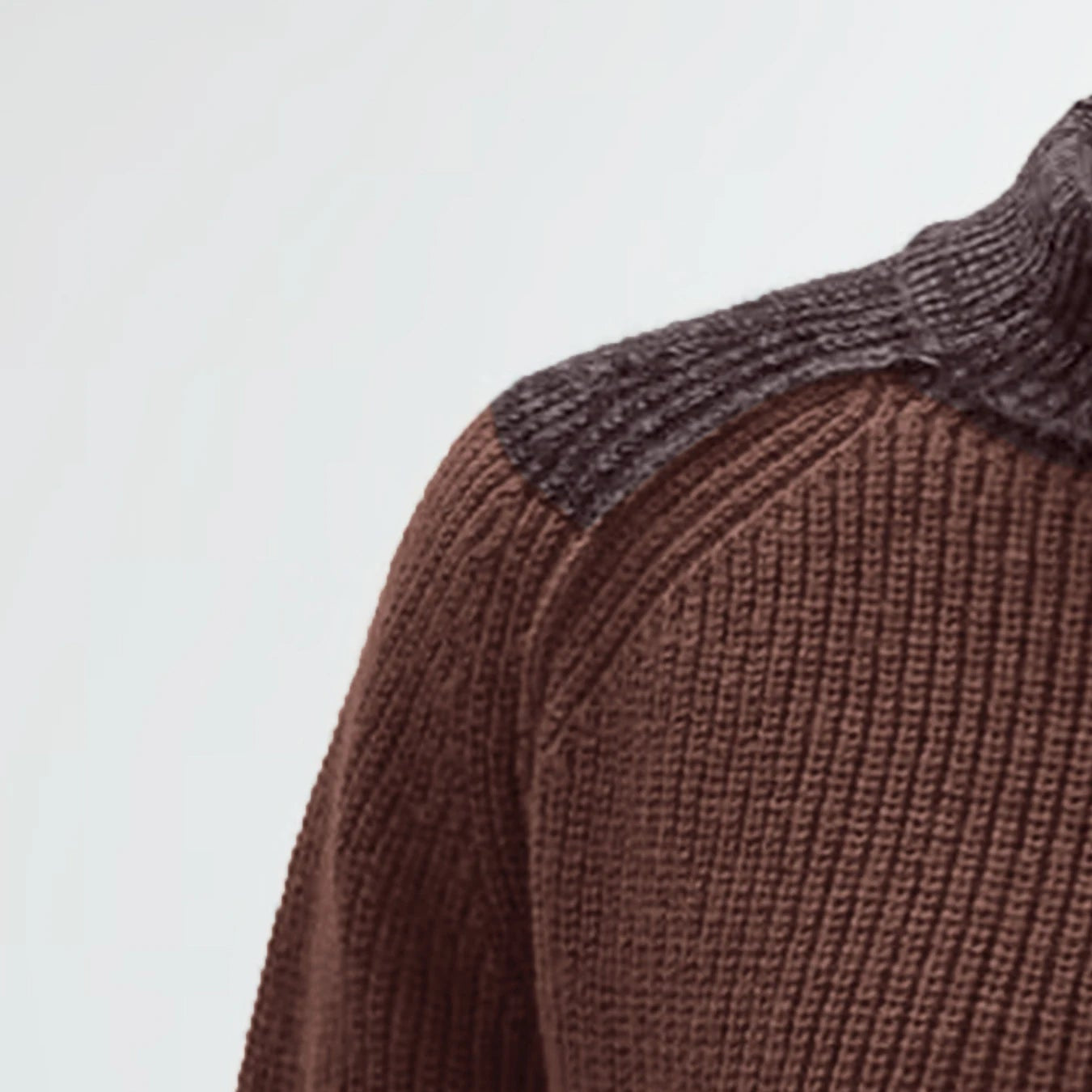 Three-quarter studio shot of the brown mock neck pullover knit sweater with contrast technical sleeve panelling.