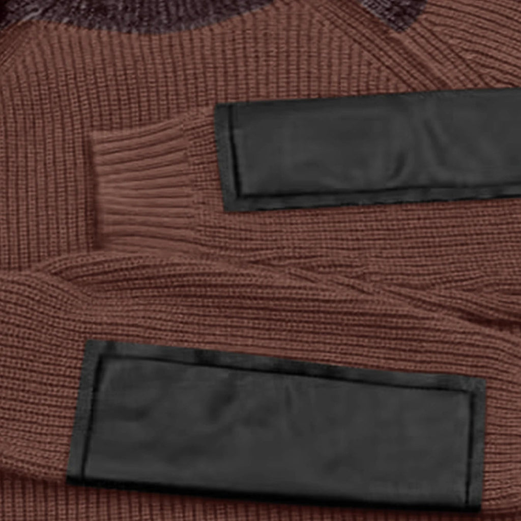 Detailed view of the black faux-leather contrast panels on the ribbed cuffs of the brown knit sweater.