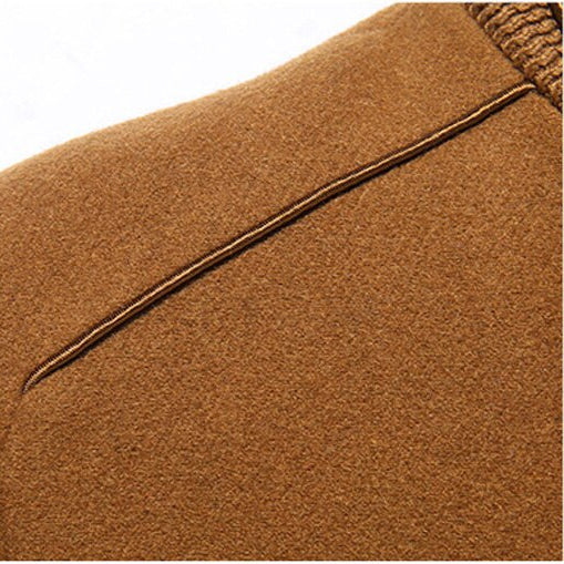 Detailed macro shot of the MONTQUANT Trench Jacket shoulder and back yoke seam, highlighting the heavyweight premium textile weave texture and minimalist, unbranded finish.