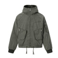 Front view of the Montquant Shearling-Lined Hooded Jacket in a washed olive green canvas, highlighting its high-zip neck, heavy utility cargo pockets, and adjustable hem drawstrings.