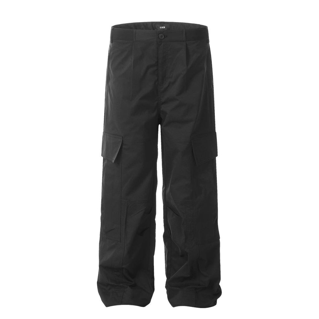 Full-length view of the MONTQUANT Straight Outdoor Trousers in monochrome Black, illustrating the clean, minimalist look of the dark performance canvas fabric.