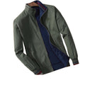 Front view of the Montquant Reversible Stand-Collar Jacket, showcasing its smooth olive green exterior shell, dark navy blue lining reveal, clean zip closure, and ribbed cuffs.