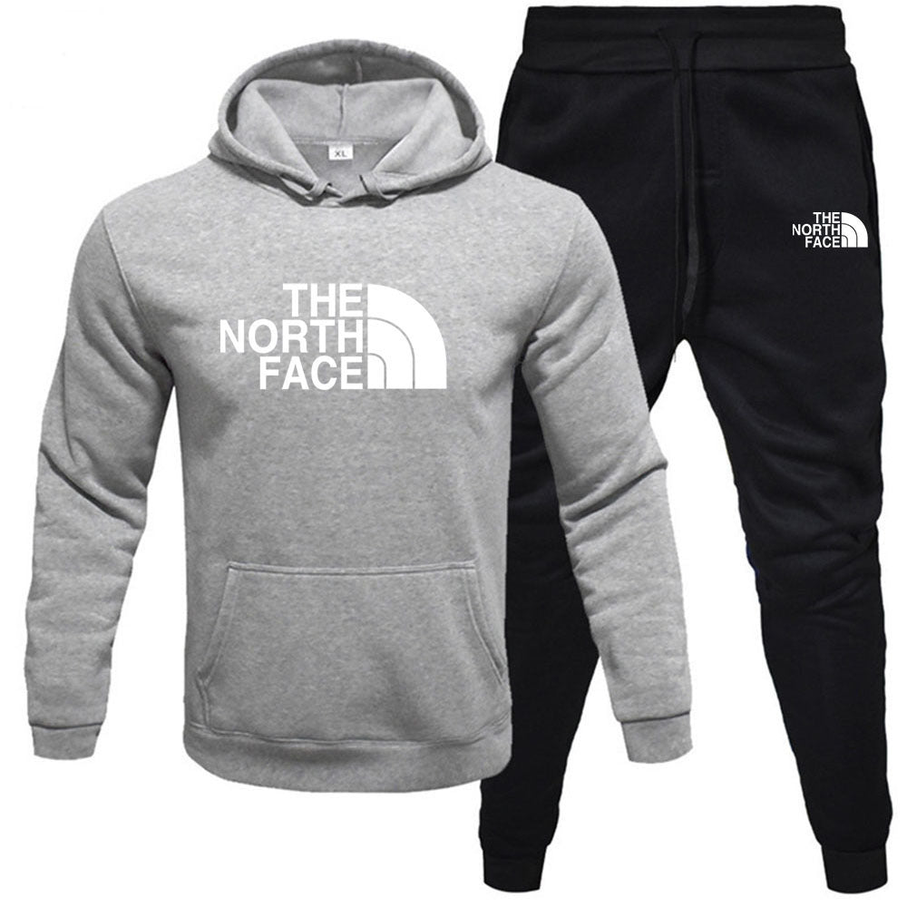 Studio presentation of the MONTQUANT matching sportswear set featuring a heather grey pullover hoodie paired with contrasting deep black fleece jogger pants.