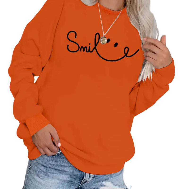 Model wearing the Burnt Terracotta Orange variant of the long-sleeve crewneck sweatshirt.
