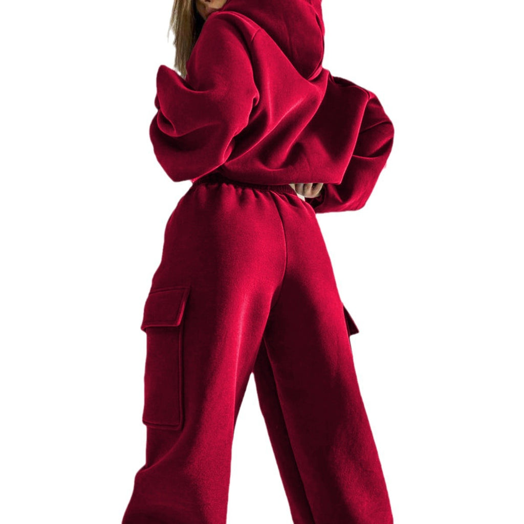 A clean profile shot from the back of a model wearing a deep crimson red matching hoodie and cargo trouser set.