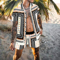 Front studio view of the MONTQUANT Leisure Print Resort Set in a monochrome black, orange, and white geometric tile print, displaying the unbuttoned short sleeve shirt and matching drawstring shorts.