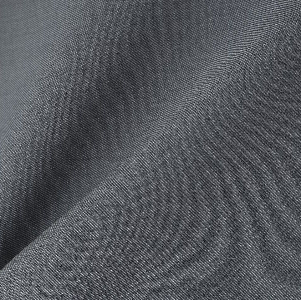 Detailed macro shot of the premium gray suit fabric showing a smooth texture and tight weave