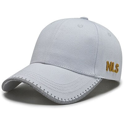 Side profile view of the signature structured cotton baseball cap in light gray, highlighting the clean 6-panel paneling and refined gold embroidery on the side panel.