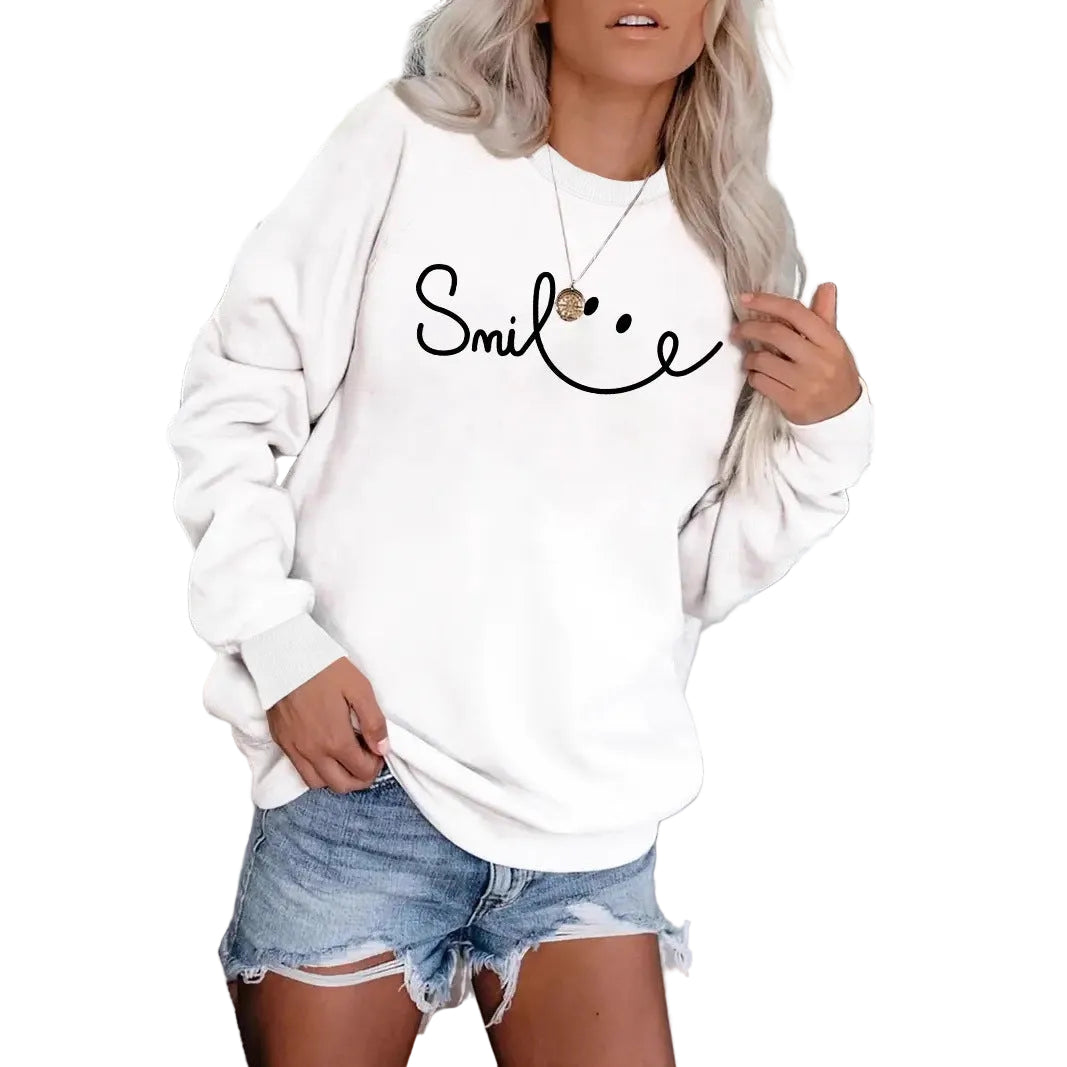 Front view of a model wearing the white MONTQUANT Smile graphic crewneck sweatshirt styled with denim shorts.