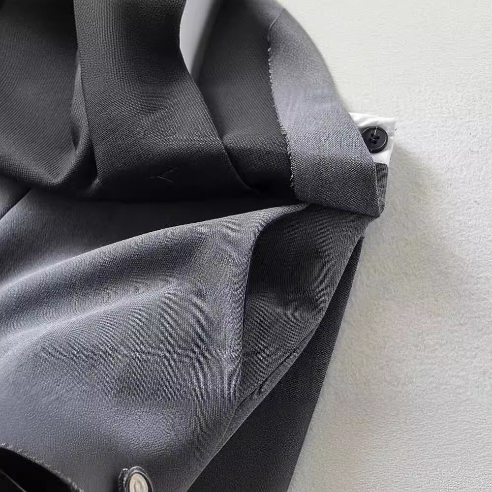 Gray cotton fabric texture and side button detail of MontQuant pleated mini skirt