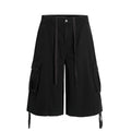 Front view of the Montquant Utility Workwear Short in a solid matte black, showcasing its wide-leg relaxed silhouette, prominent side cargo pockets, and extended tonal drawstring accents.