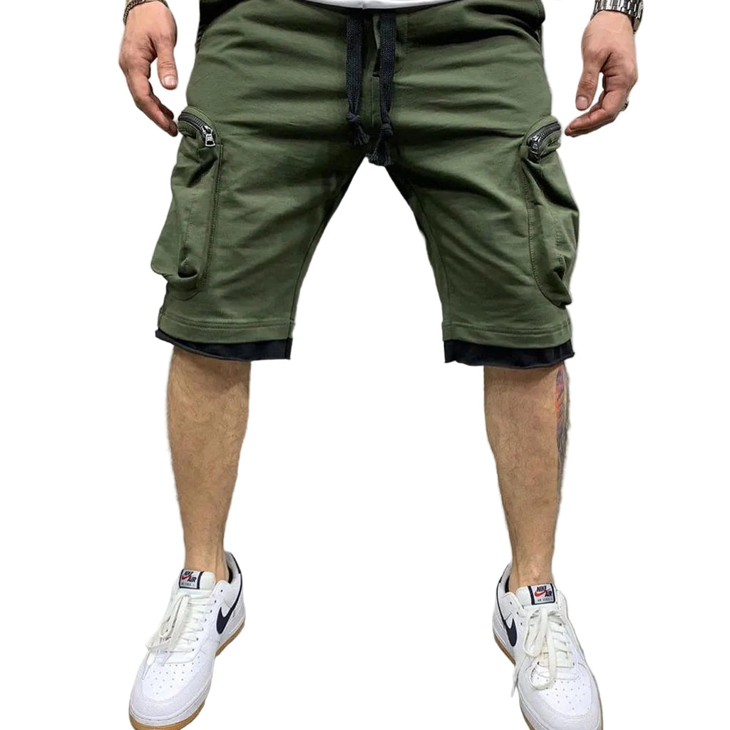 Studio presentation of the MONTQUANT Layered Fitness Cargo Shorts in Olive Green, highlighting the structured slim-fit cut, deep utility compartments, and white sneaker pairing.