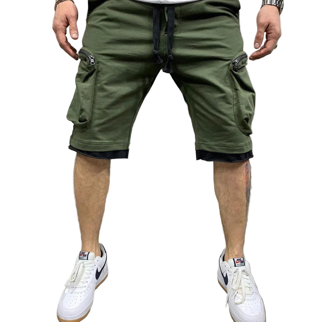 Studio presentation of the MONTQUANT Layered Fitness Cargo Shorts in Olive Green, highlighting the structured slim-fit cut, deep utility compartments, and white sneaker pairing.