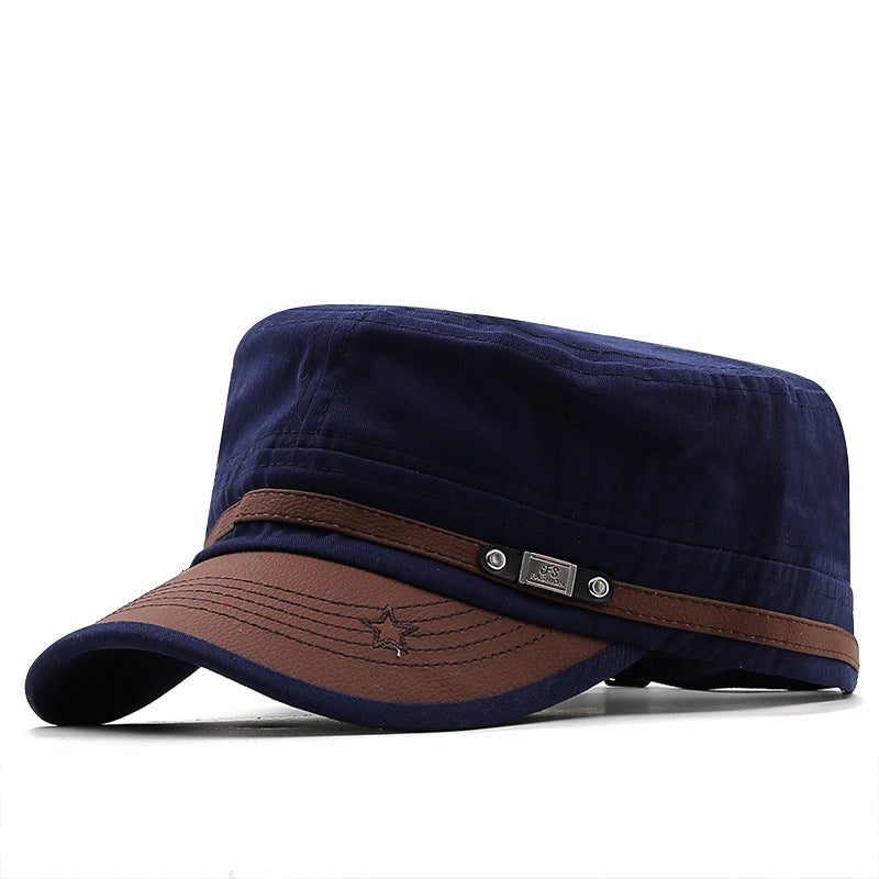 MontQuant tech-cotton flat top field cap in Maritime Navy blue featuring a structured crown, a contrasting dark brown faux-leather curved brim, and a sleek metallic side emblem.