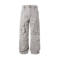 Front view of Montquant Deconstructed Vintage Trousers in a washed grey premium fabric, showcasing a relaxed silhouette, structured cargo pocket paneling, and unique architectural seam stitching.