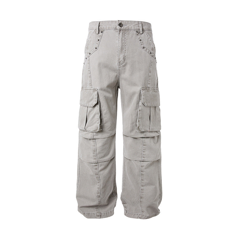 Front view of Montquant Deconstructed Vintage Trousers in a washed grey premium fabric, showcasing a relaxed silhouette, structured cargo pocket paneling, and unique architectural seam stitching.