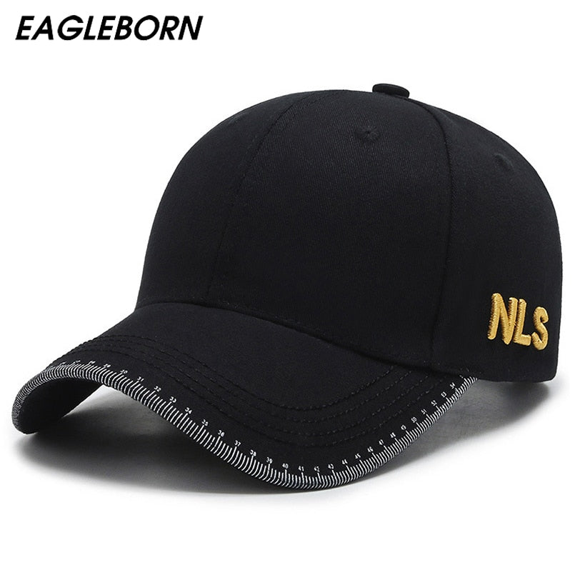 Front profile shot of MontQuant's signature structured cotton baseball cap in matte black, showcasing the curved brim with white geometric contrast stitching and subtle gold side embroidery.