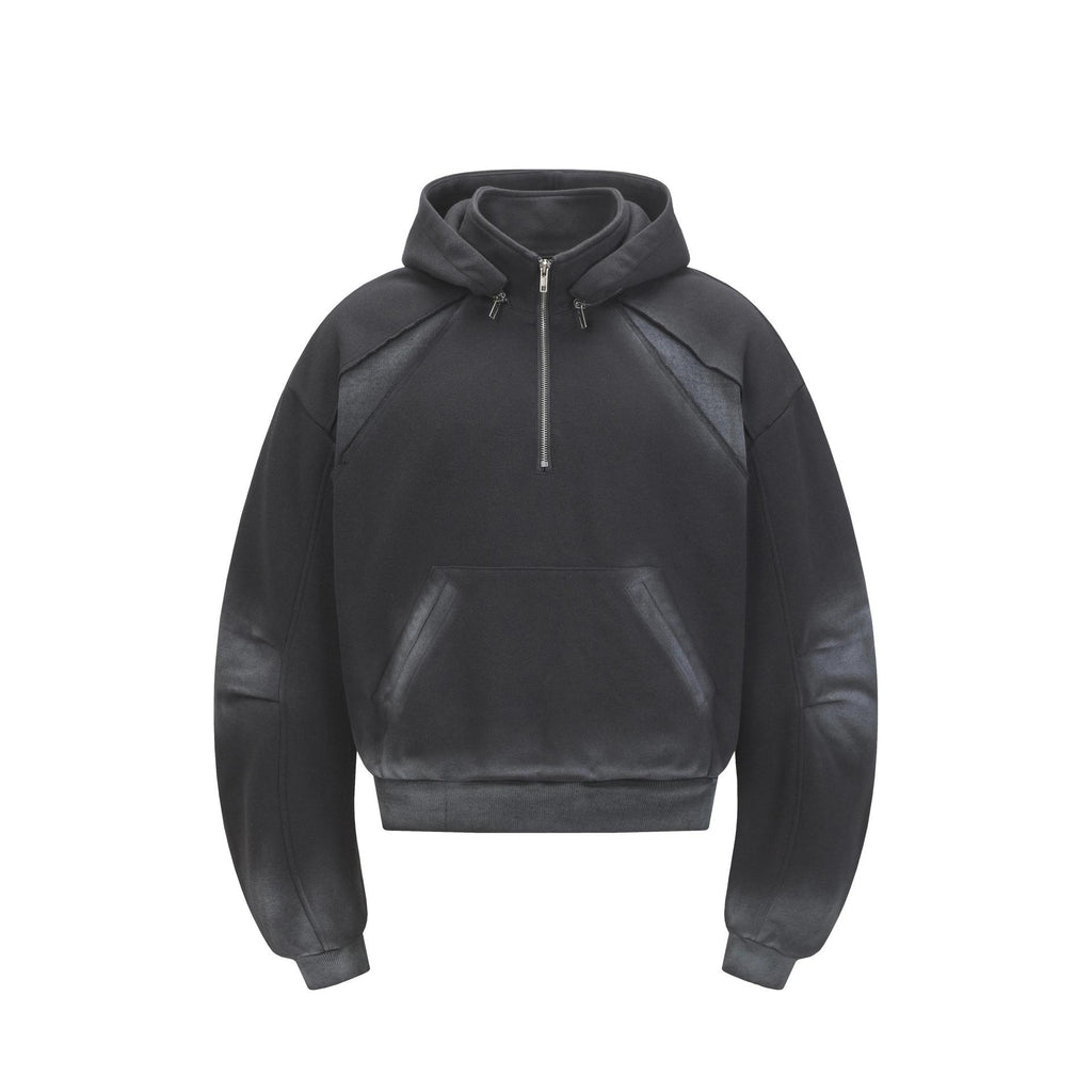Front view of the Montquant Heavyweight Half-Zip Hoodie in a washed black hue, showcasing its slouchy drop-shoulder cut and deep double-layered hood construction.