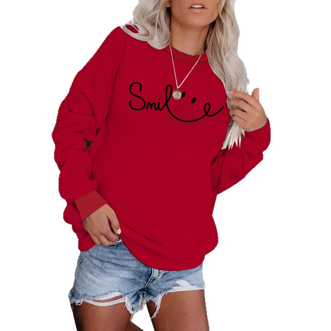 Model wearing the Crimson Red version of the relaxed-fit Smile typographic sweatshirt.