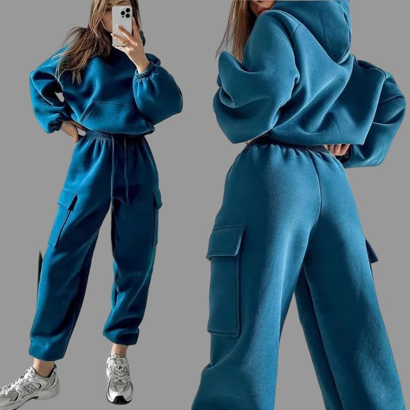 Front and back view of a model in a vibrant steel blue matching pullover hoodie and cargo trousers set.