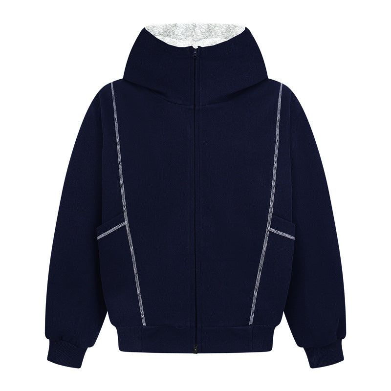 Side-angle back view of the navy blue technical deconstructed hoodie, showcasing the precision white contrast line stitching along the drop shoulder seams and structured back panel.