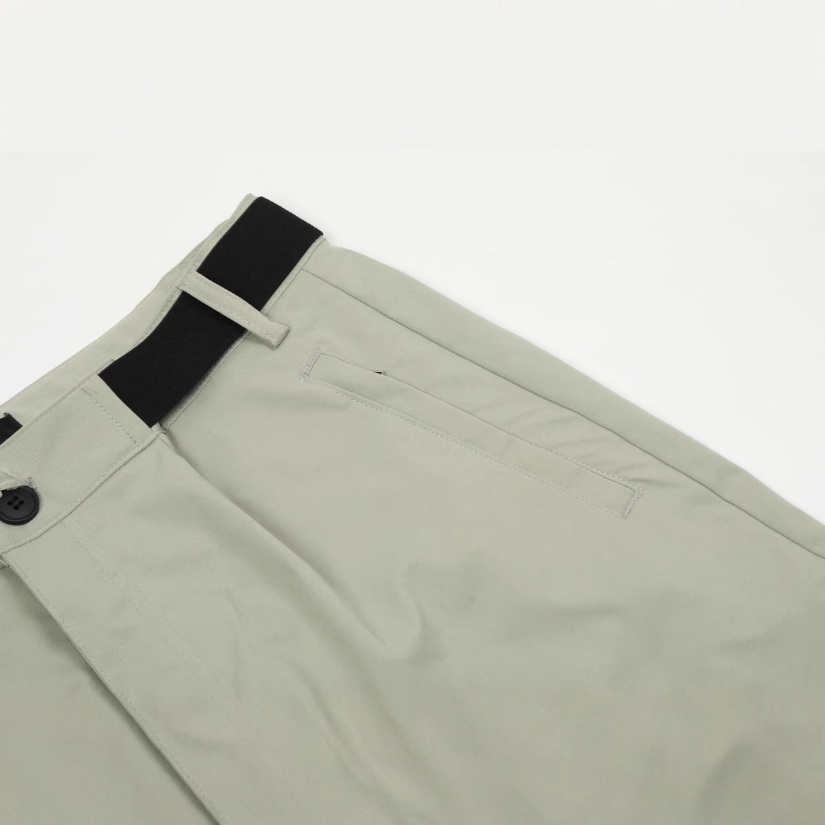 Close-up technical detail of the MONTQUANT Outdoor Trousers waistband, highlighting the black integrated hook-and-loop adjustment strap and reinforced edge stitching.