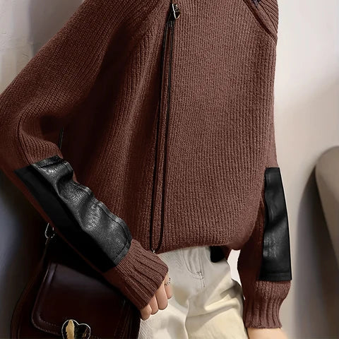 Front view of woman wearing the MONTQUANT Asymmetric Patchwork Knit Pullover in brown with black faux-leather sleeve accents.