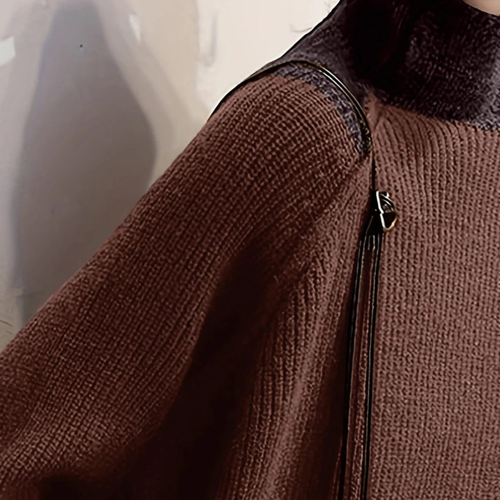 Close-up detail of the textured knit pattern and structural shoulder seam on the brown patchwork sweater.
