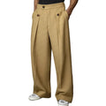 Front view of a model wearing the Montquant Relaxed Straight Suit Pant in a rich khaki tan hue, highlighting the distinct front double pleats, high-waisted button-band detailing, and loose, straight-leg drape over sneakers.