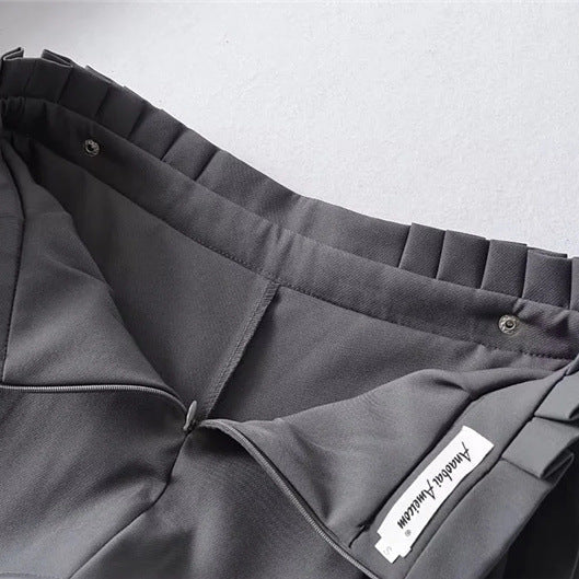 Interior view of the dark grey skort, showing the construction of the integrated inner shorts lining and back zipper closure.