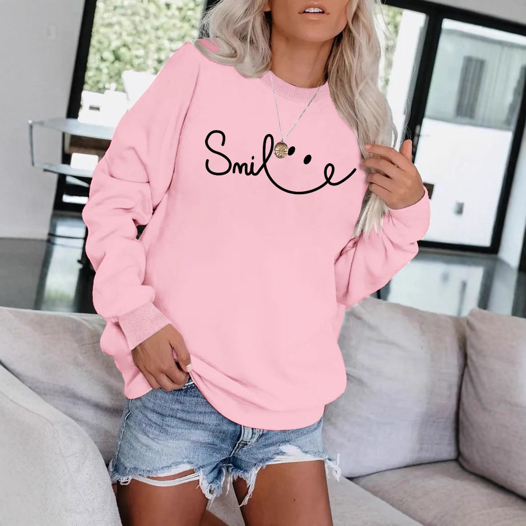 Model wearing the Blossom Pink variant of the cotton-blend graphic sweatshirt.
