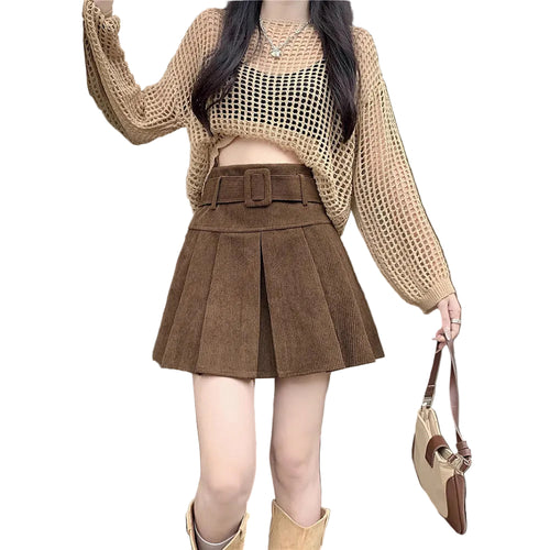 On-model shot featuring the brown skirt paired with a beige knit cardigan, black top, and a small handbag.