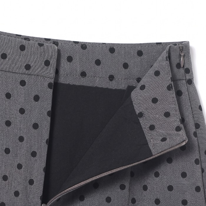 Inside detail showing the black inner lining and waistband construction of the grey polka dot skirt