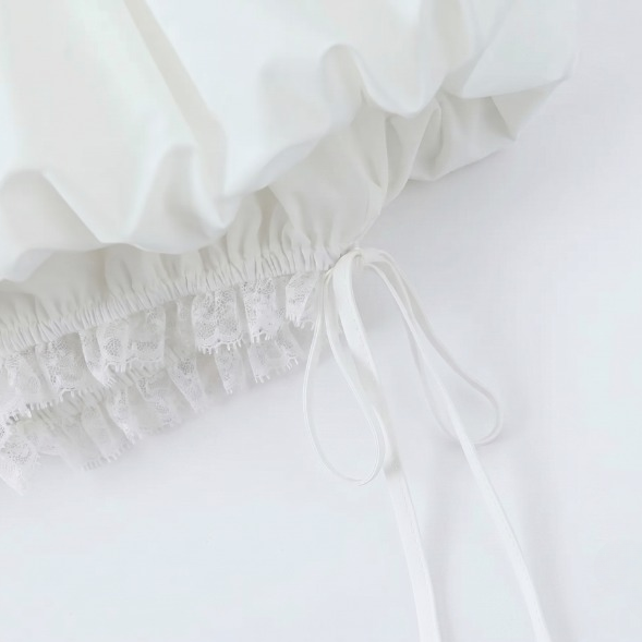 Close-up detail of the white gathered fabric and drawstring tie on the lace fluffy skirt