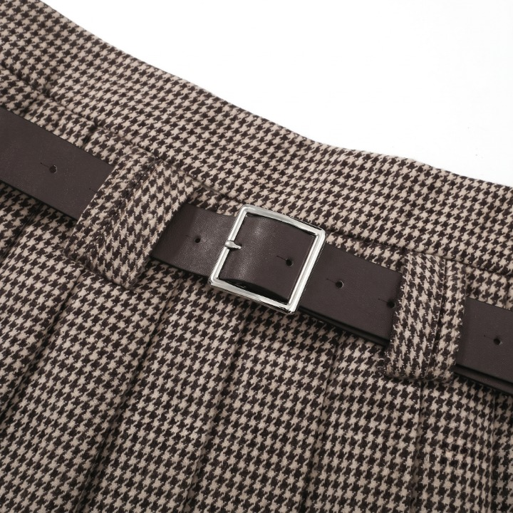 Close-up detail of the classic houndstooth patterned fabric, pleating structure, and belt loops