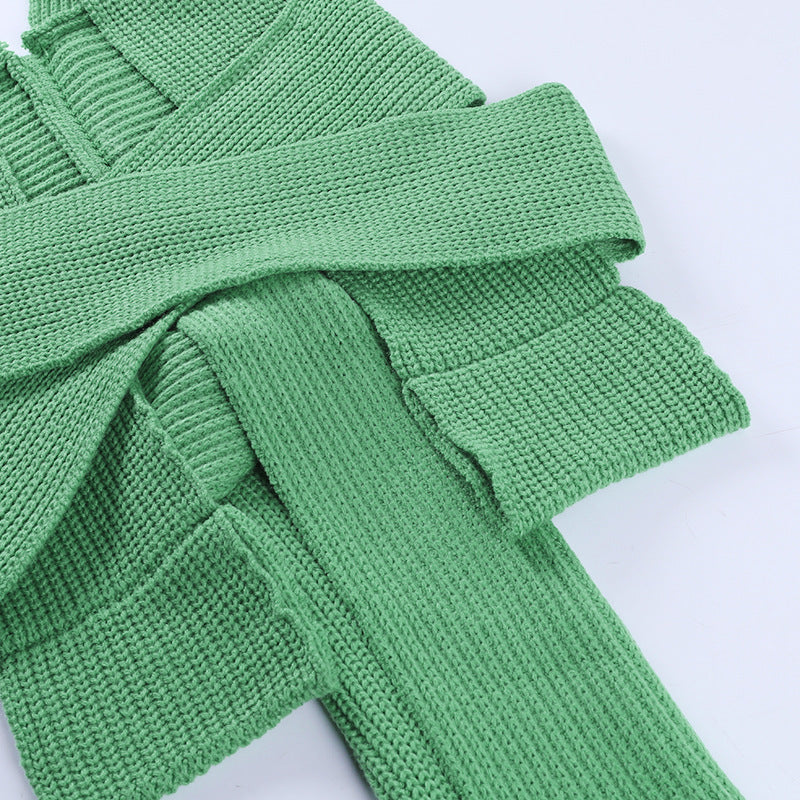 Flat lay view of the back construction and structural strap orientation of the green ribbed knit halter top.