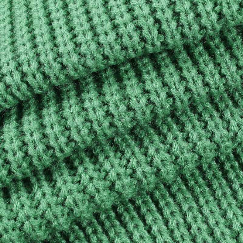Detailed macro shot of the high-density knit matrix and ribbed texture on the sage green wrap halter top.
